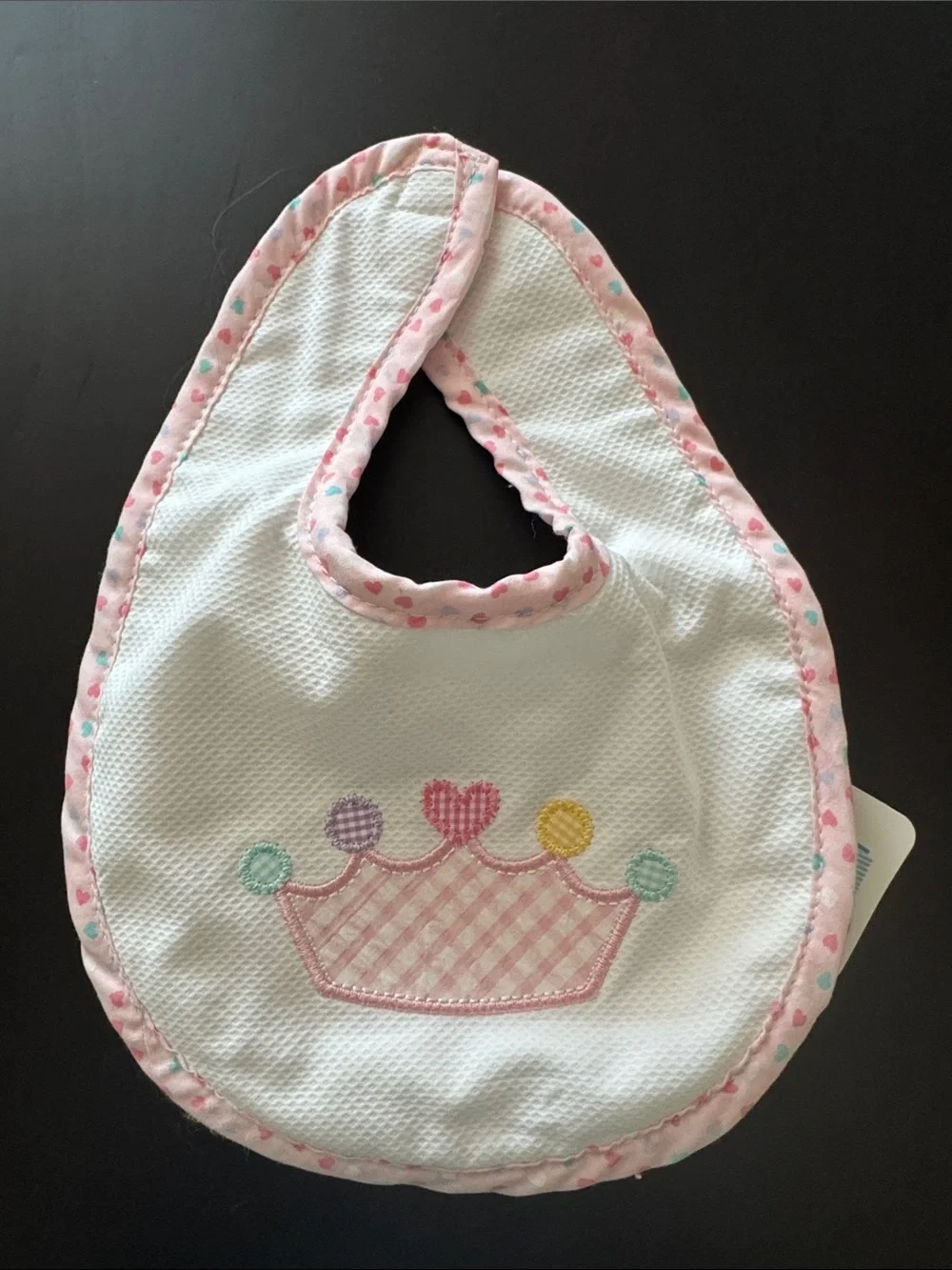 White Bib with Pink Trim and Pastel Crown Applique